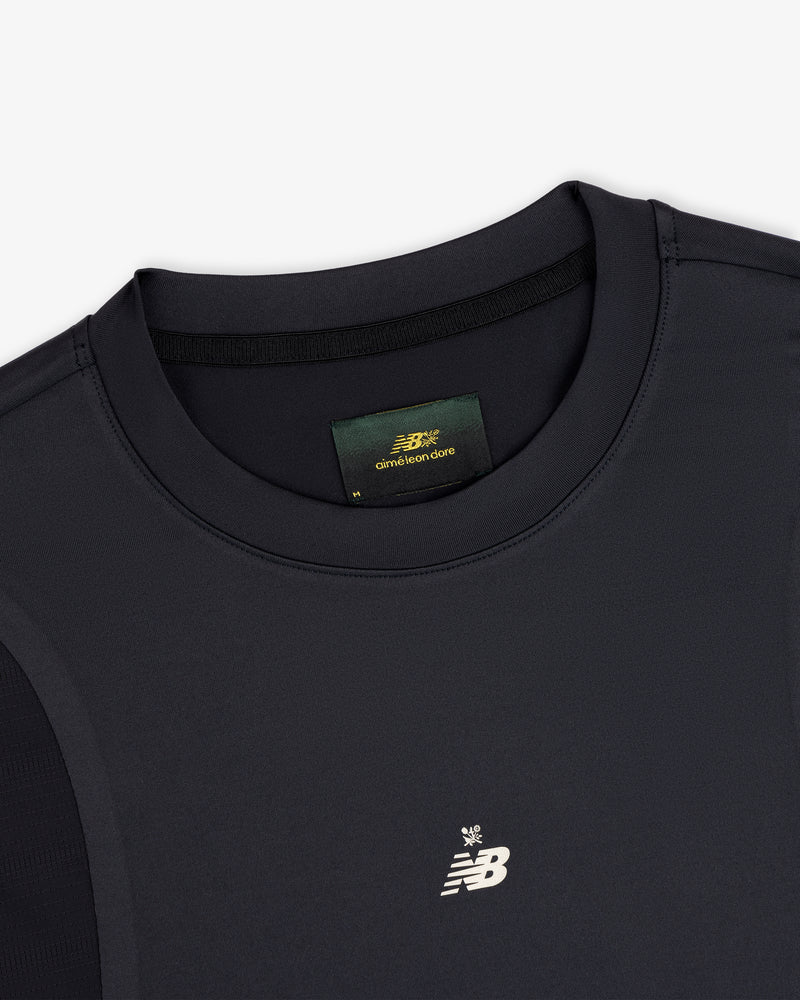 Close-up of a black ALD / New Balance Performance Long-Sleeve Tee with small logo and visible green collar label.