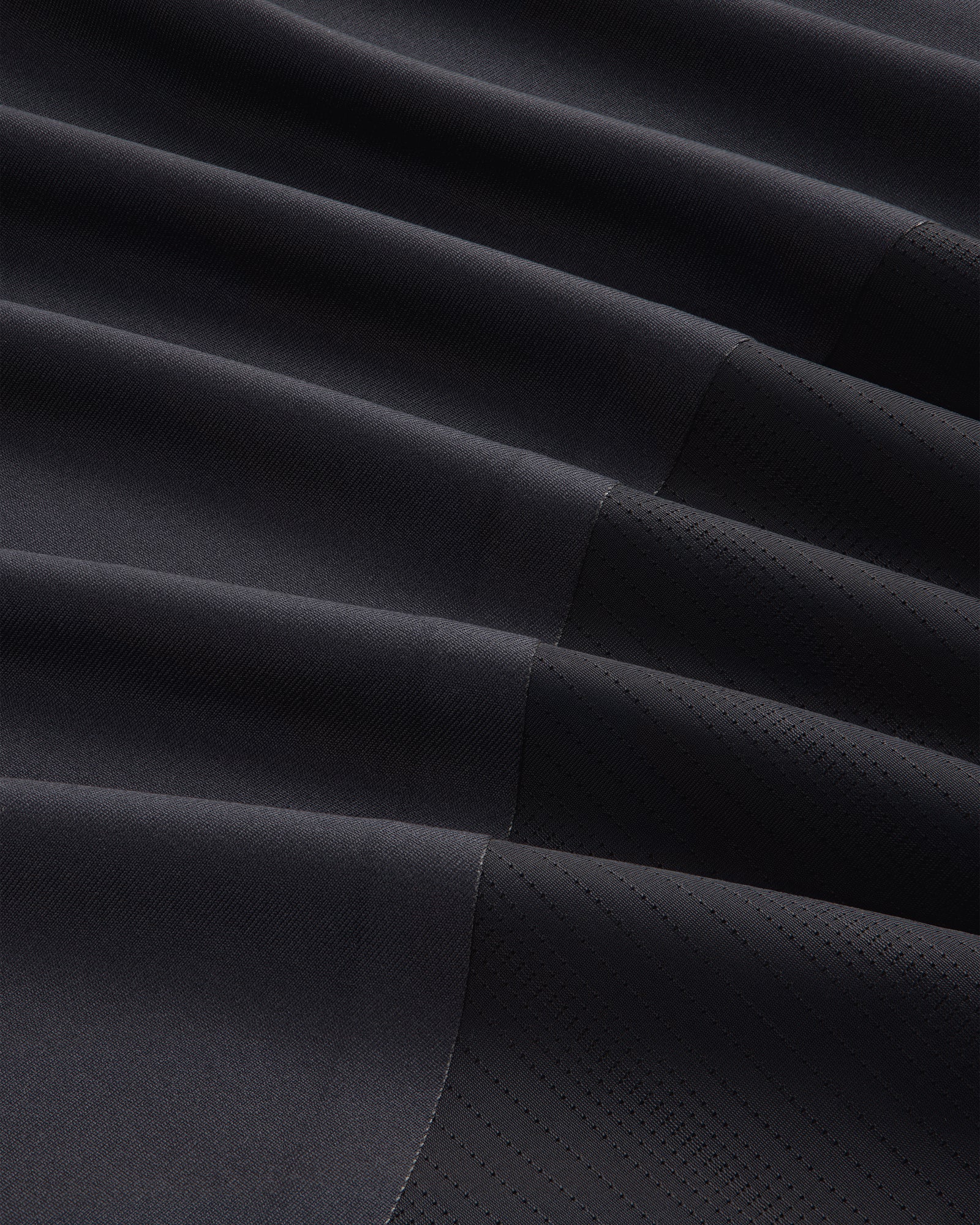 Close-up of ALD / New Balance Performance Long-Sleeve Tee in black with diagonal ribbing and stitched geometric lines.