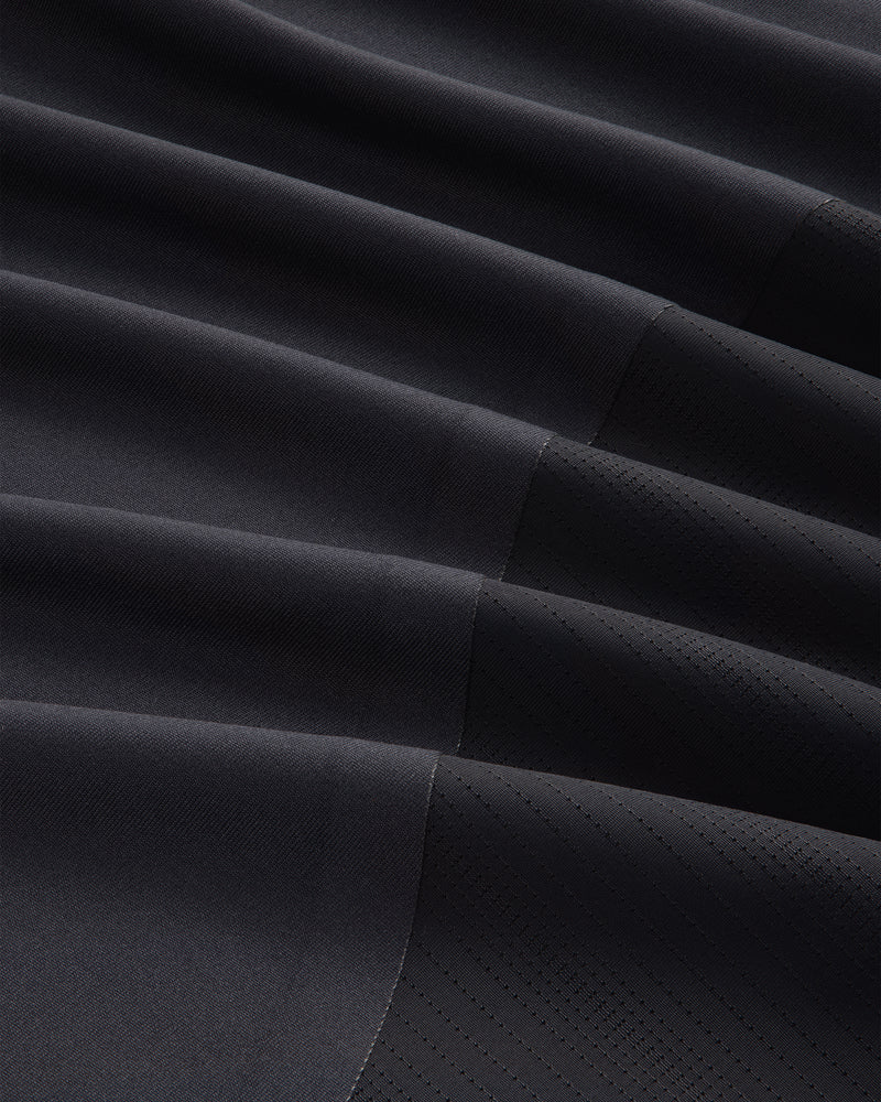 Close-up of ALD / New Balance Performance Long-Sleeve Tee in black with diagonal ribbing and stitched geometric lines.