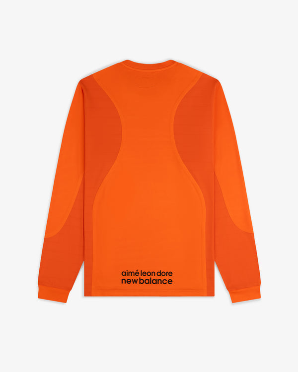 Back view of the ALD / New Balance Performance Long-Sleeve Tee in orange with black branding near the bottom hem.