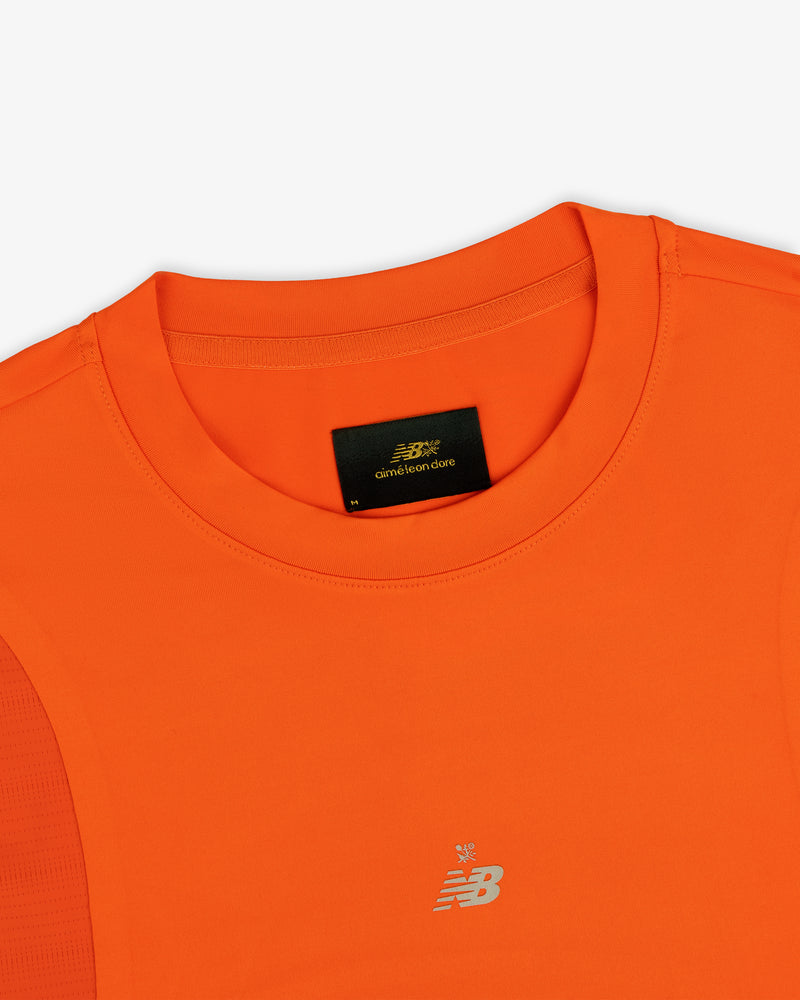 Bright orange ALD/New Balance Performance Long-Sleeve Tee with crew neckline and small silver chest logo.