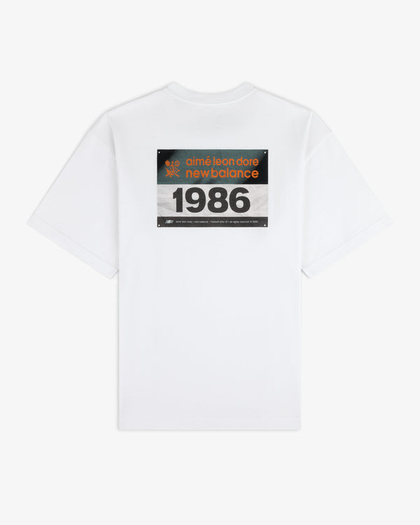 White ALD / New Balance Running Bib Tee with a large 1986 graphic on the back.
