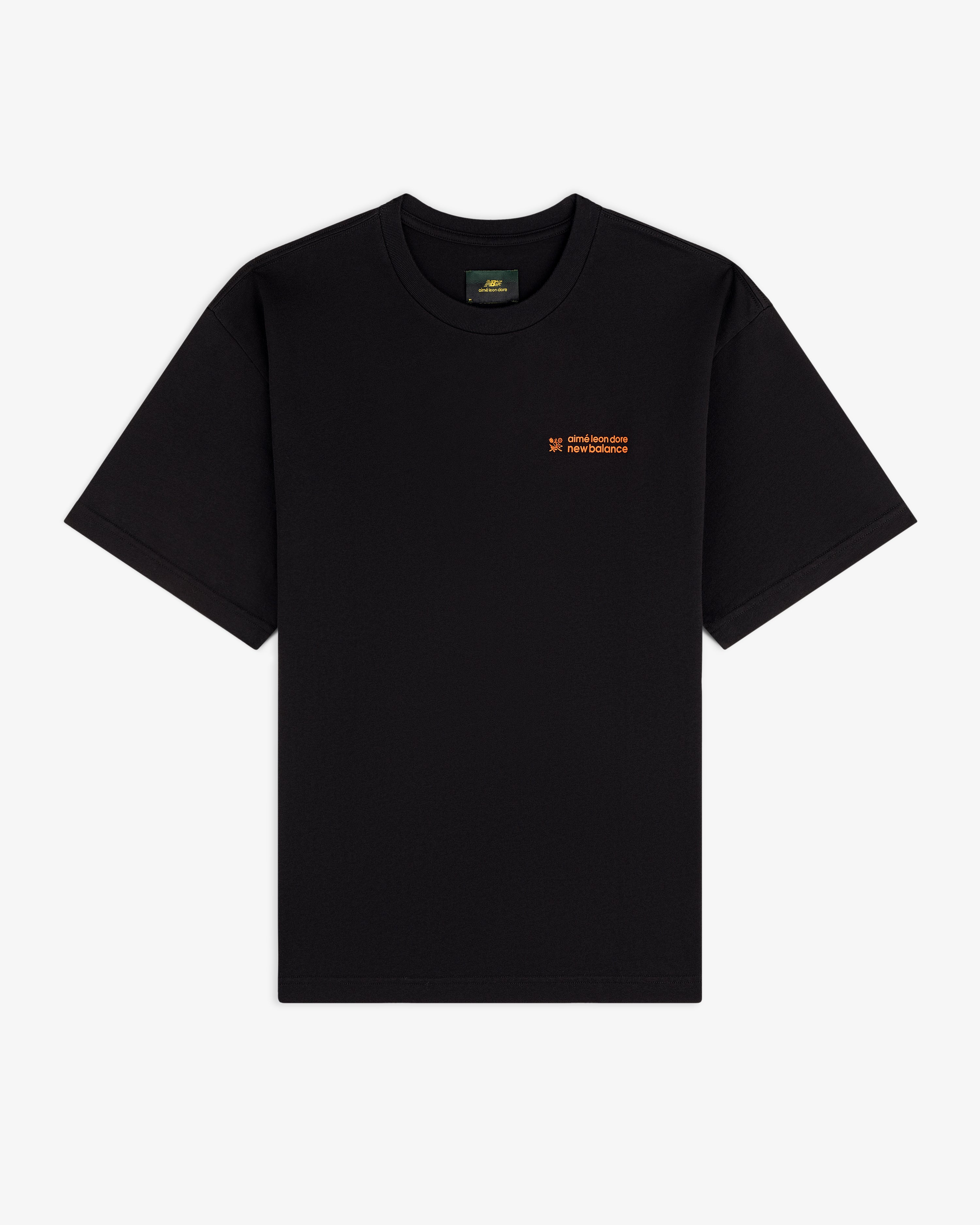 ALD / New Balance Running Bib Tee, black short-sleeve with small orange text on left chest, flat on white background.