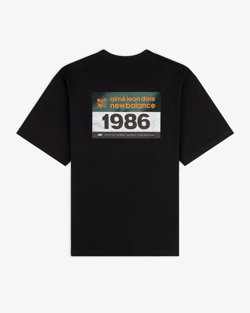 ALD / New Balance Running Bib Tee in black with rectangular "aimé leon dore new balance 1986" graphic on back.