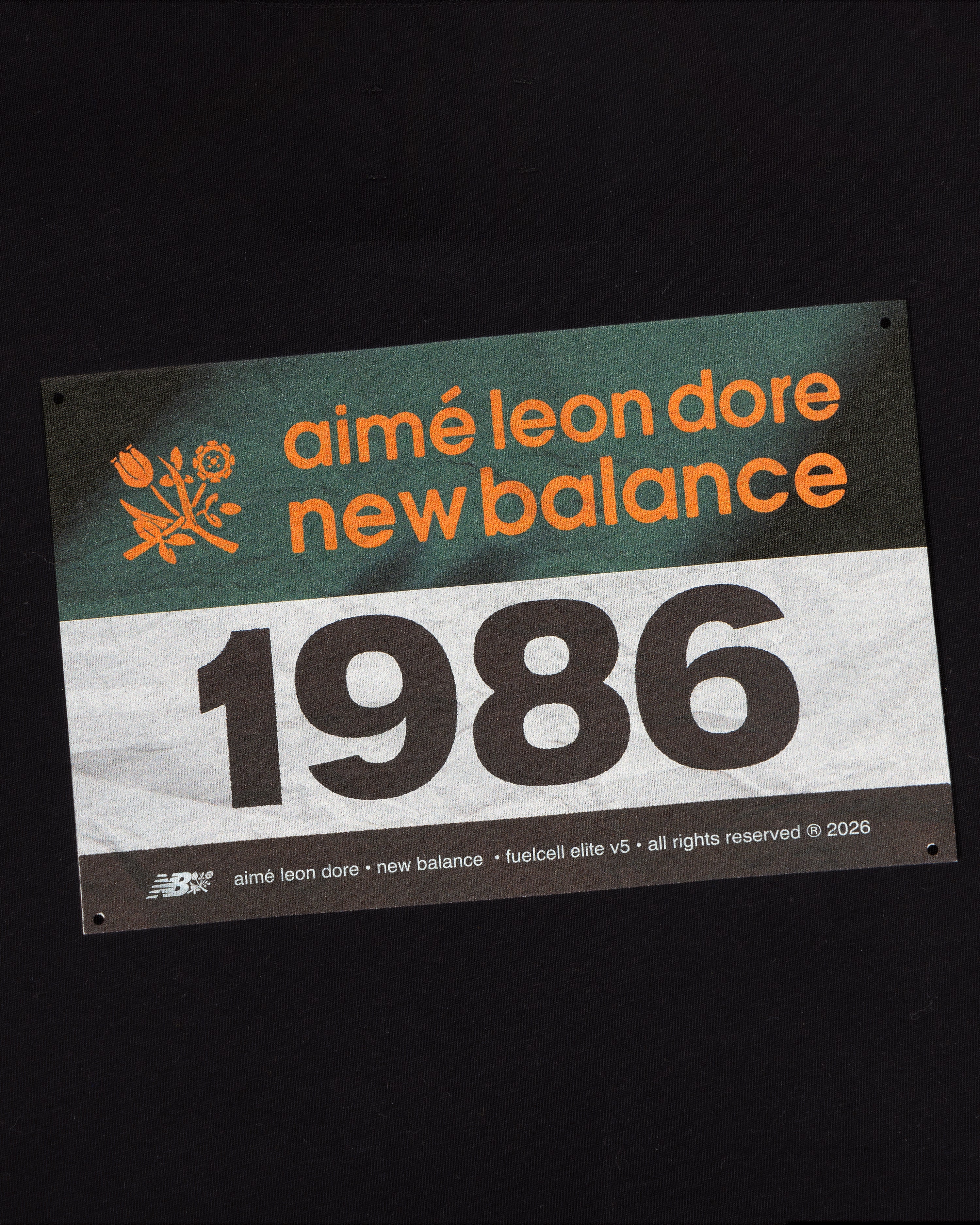 The ALD / New Balance Running Bib Tee features a race bib graphic with "aimé leon dore new balance 1986" on black.