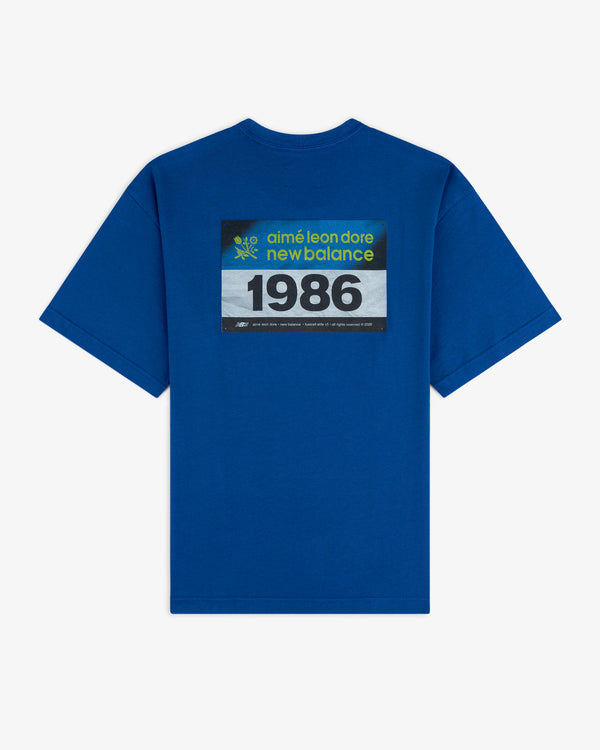 Blue ALD / New Balance Running Bib Tee with "1986" boldly printed on the back.