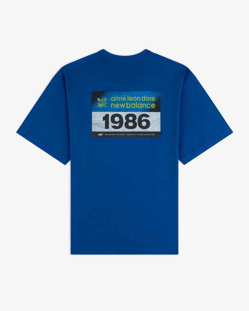 Blue ALD / New Balance Running Bib Tee with "1986" boldly printed on the back.
