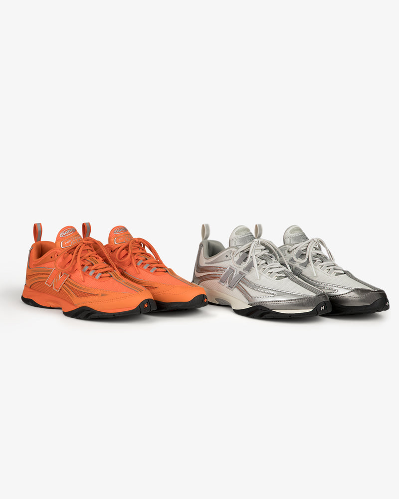 Two ALD / New Balance RC56 sneakers—one orange, one silver—displayed side by side on a white background.