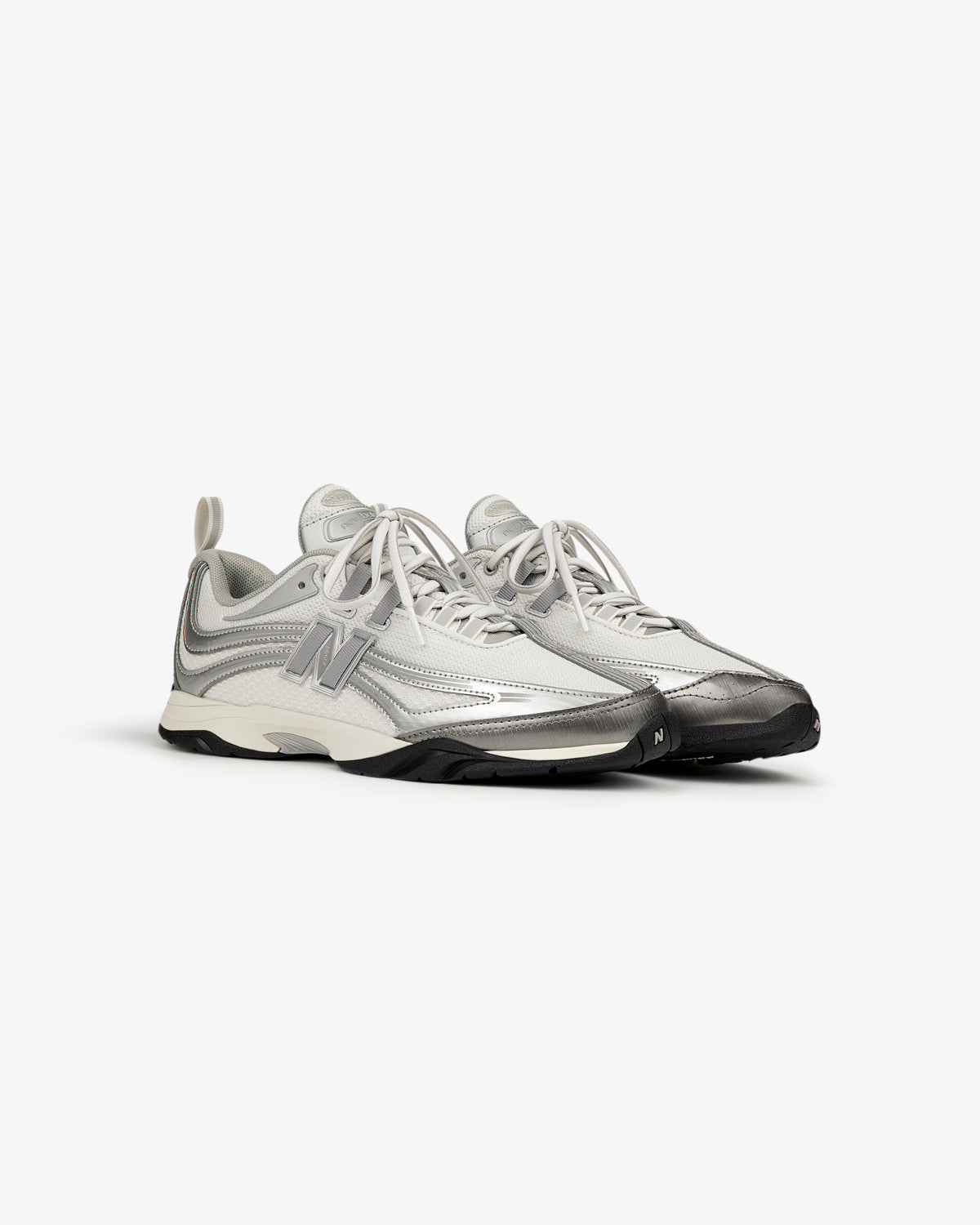 The ALD / New Balance RC56 are gray and white lace-up athletic sneakers with a large N logo on the side.