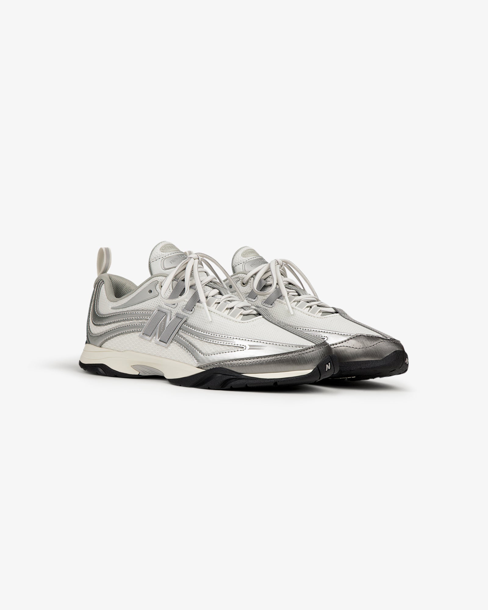 The ALD / New Balance RC56 are gray and white lace-up athletic sneakers with a large N logo on the side.