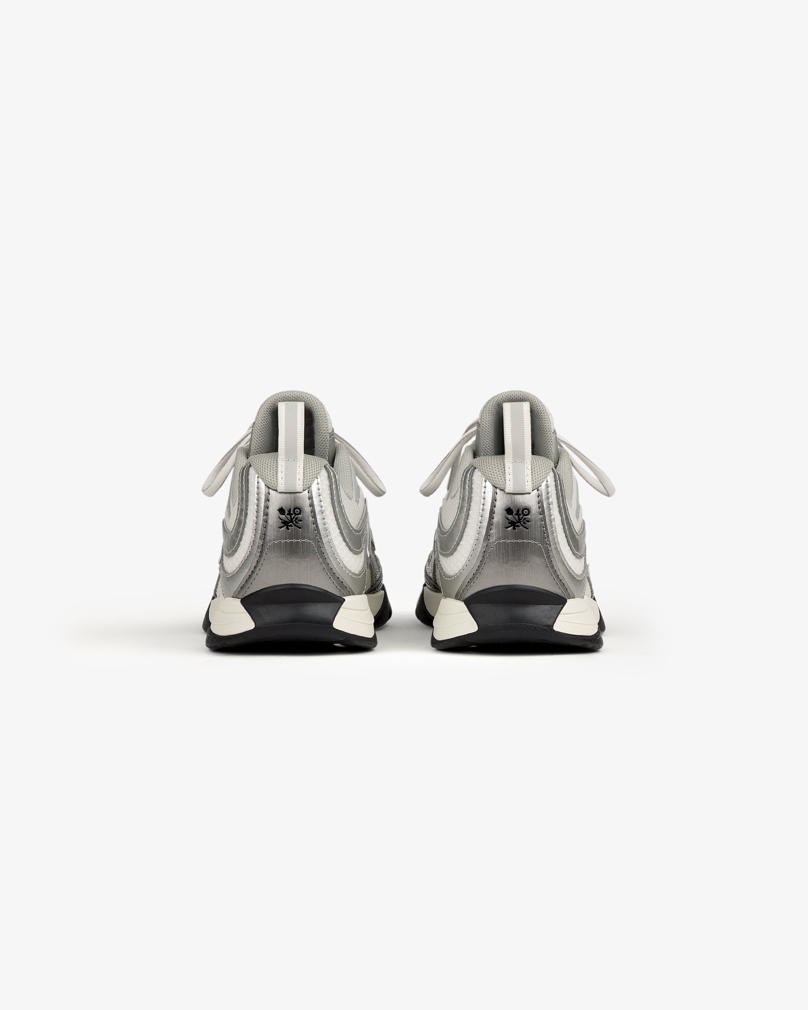 The ALD / New Balance RC56 sneakers in white and gray, viewed from the back on a plain white background.