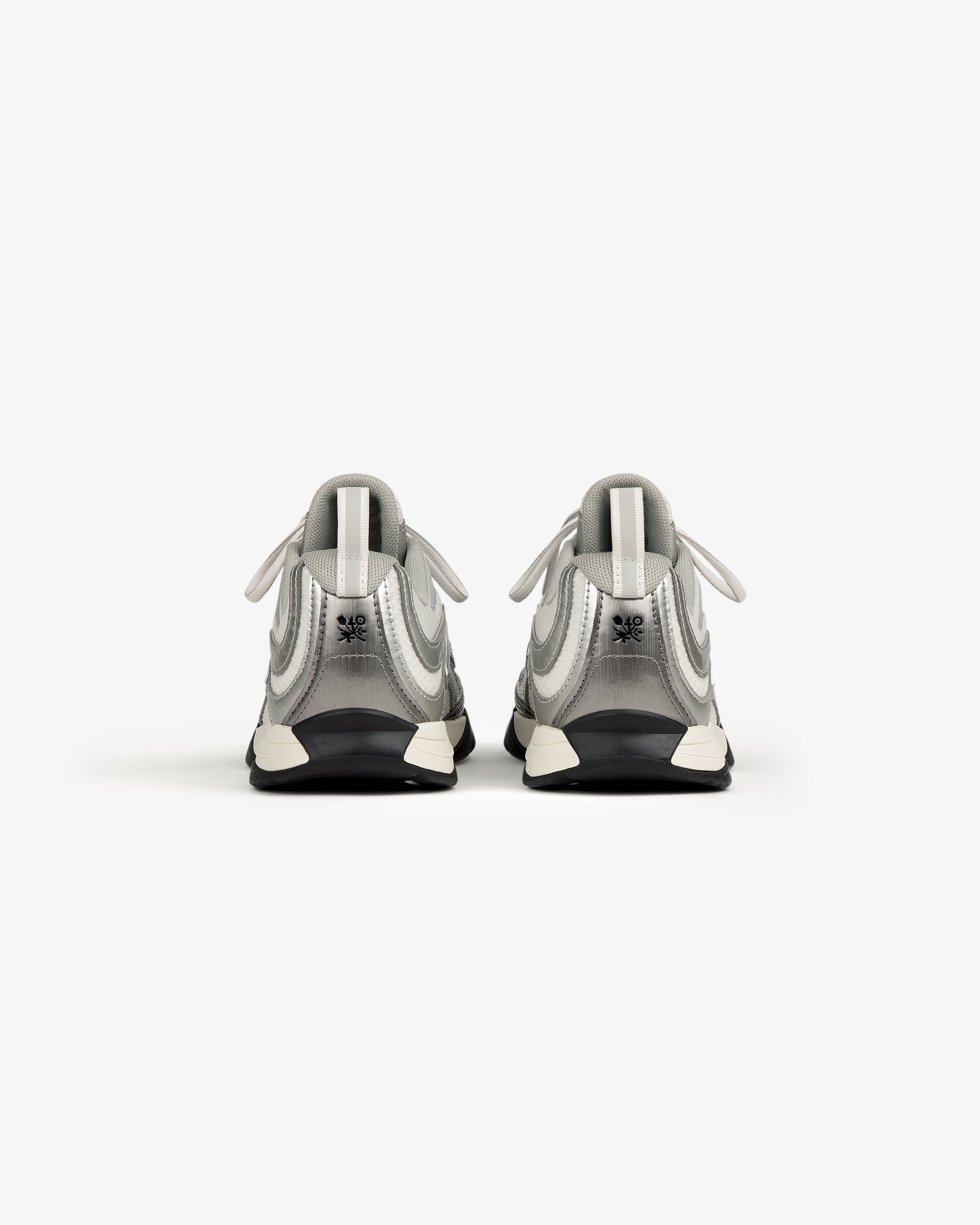 The ALD / New Balance RC56 sneakers in white and gray, viewed from the back on a plain white background.