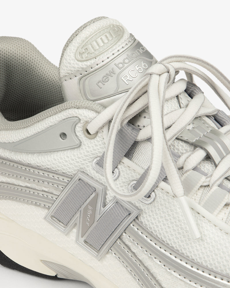 Close-up of a white and gray ALD / New Balance RC56 sneaker with laces and a bold N logo on the side.
