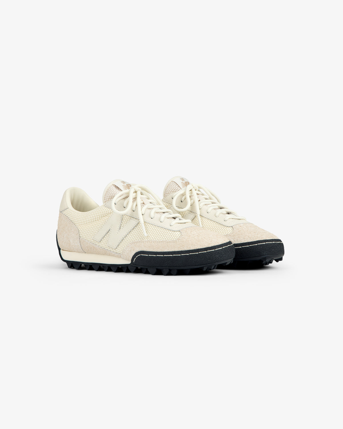 The ALD / New Balance Gator sneakers have off-white textured uppers, cream laces, and black rugged soles.