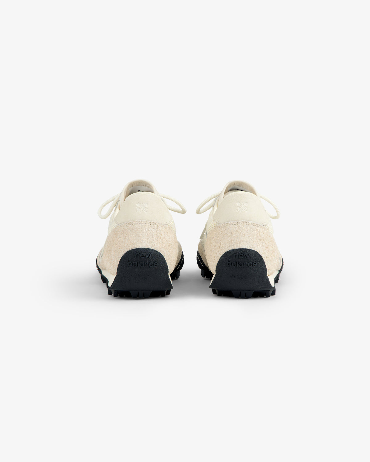 Rear view of ALD / New Balance Gator sneakers in off-white with black soles on a plain white background.