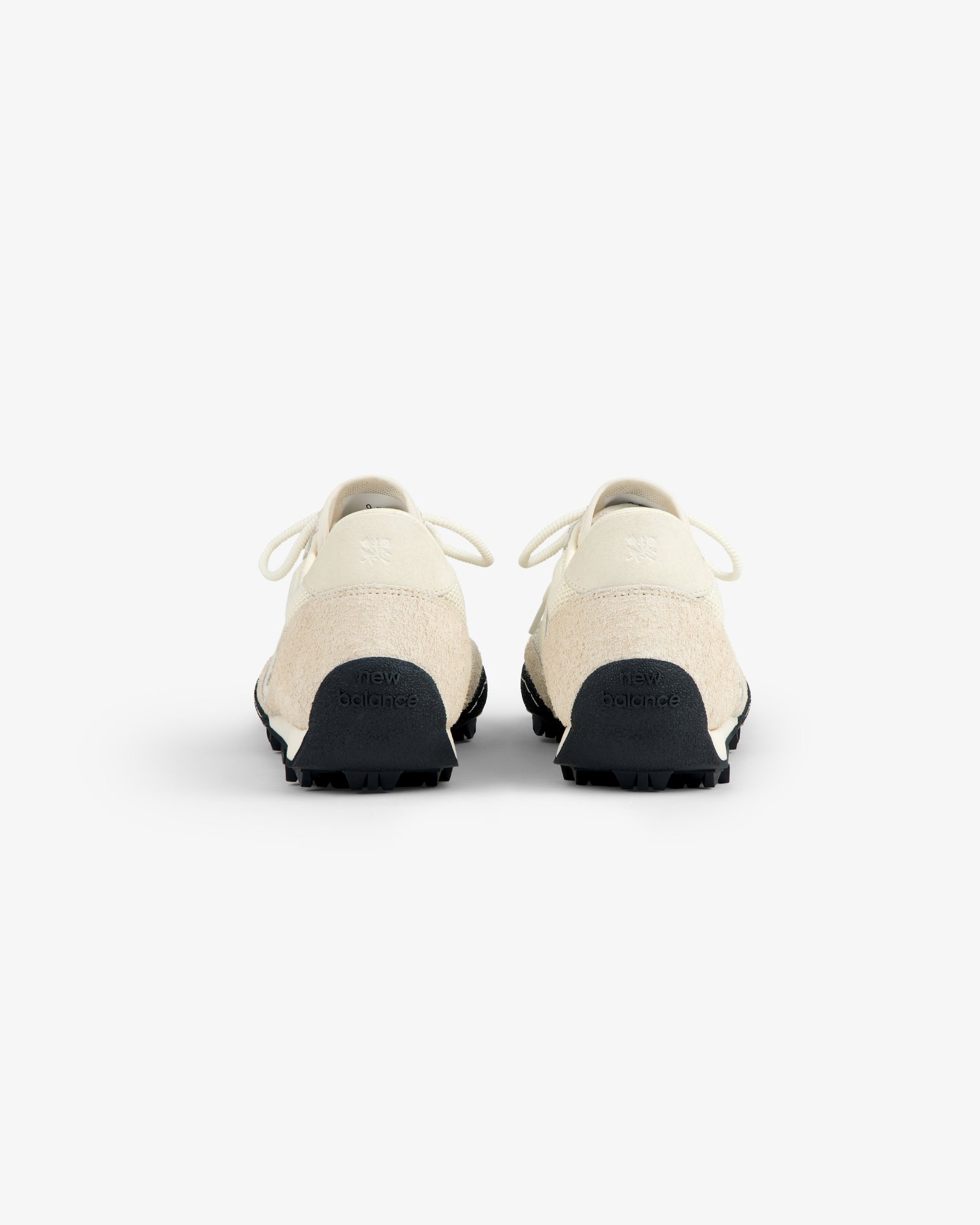 Rear view of ALD / New Balance Gator sneakers in off-white with black soles on a plain white background.