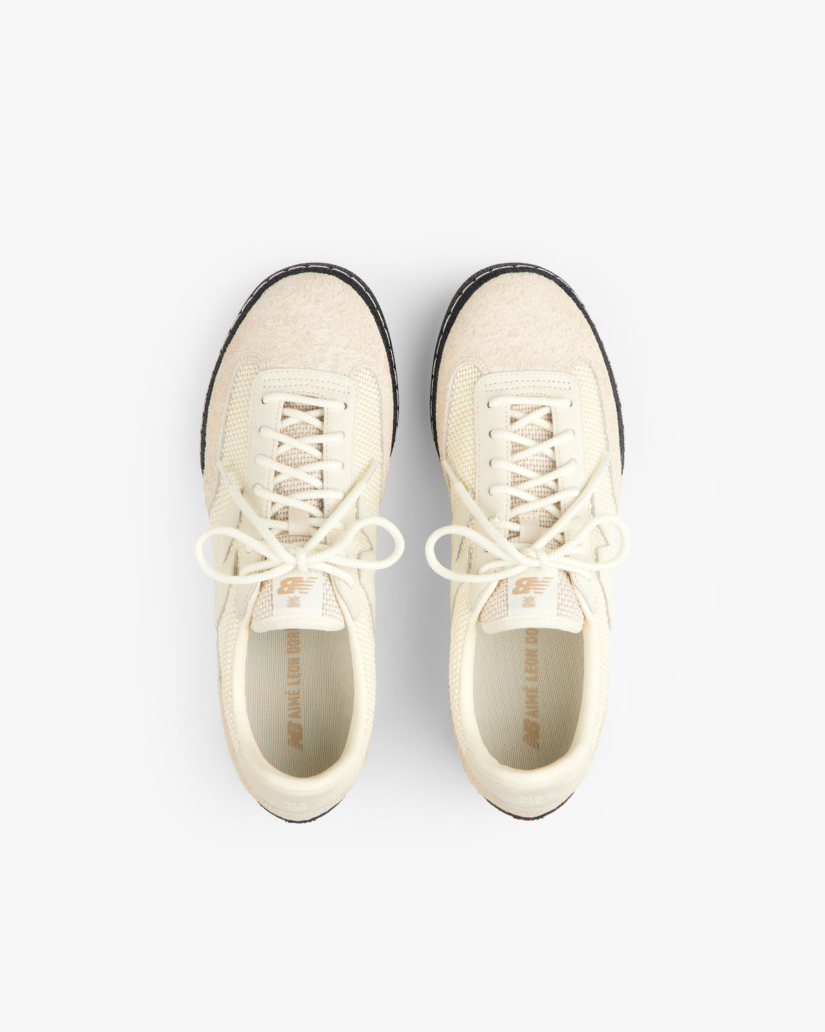 The ALD / New Balance Gator sneakers in cream with white laces, shown from above on a white background.