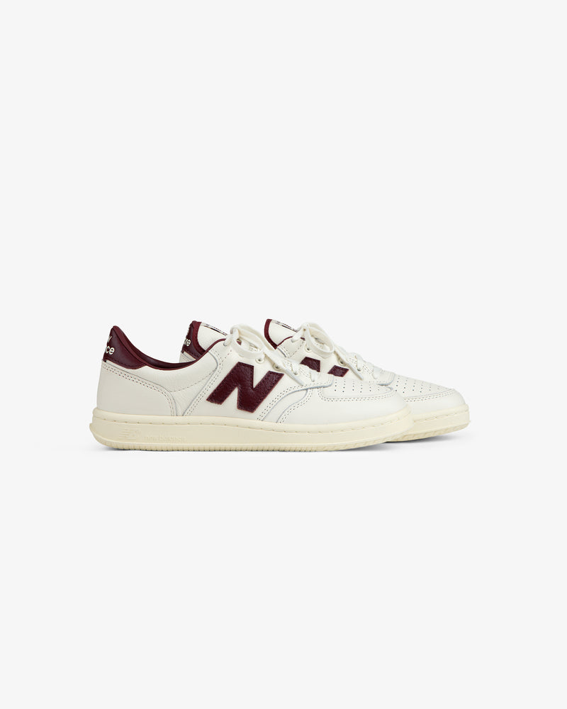 Off-white leather ALD / New Balance T500 Tennis Oxfords with a dark red logo and heel tab.