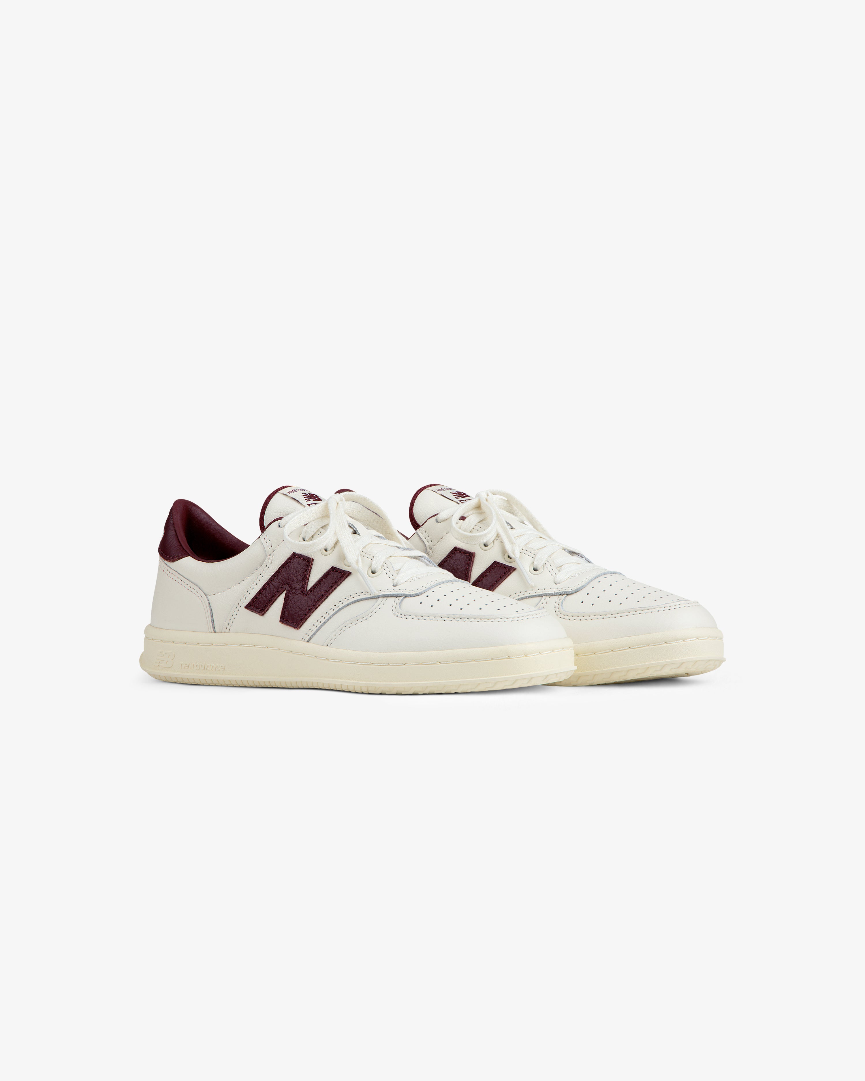 Off-white ALD / New Balance T500 Tennis Oxfords with burgundy accents and a logo on the side.