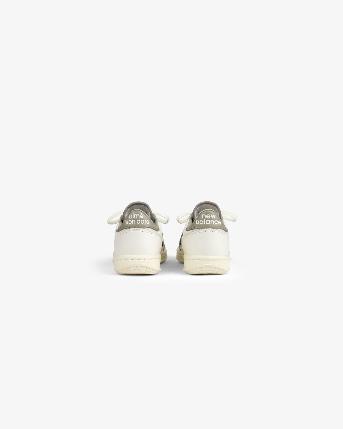 Rear view of ALD / New Balance T500 Tennis Oxfords in off-white with gray branded heel tabs.