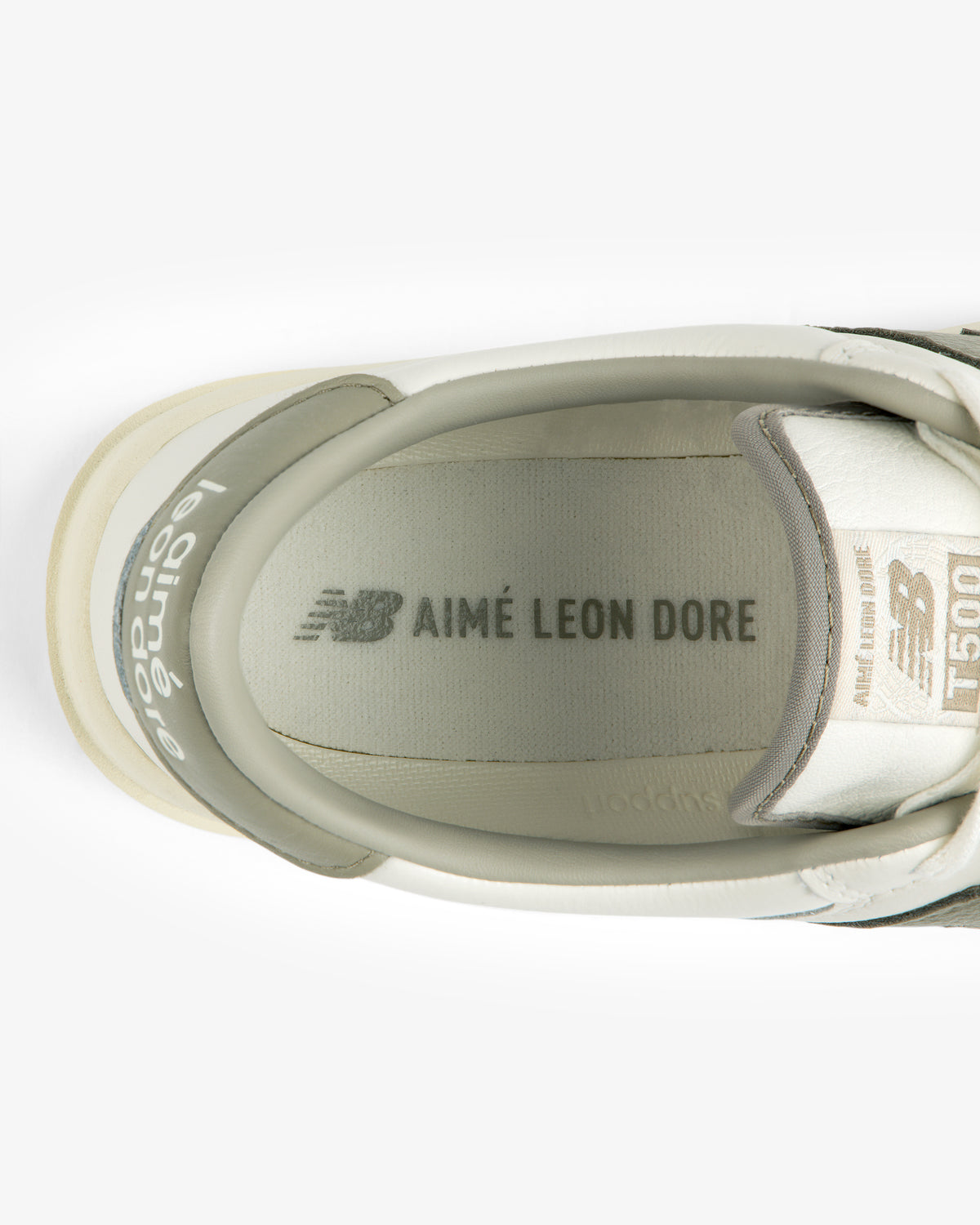 Top-down view of the inside of an ALD / New Balance T500 Tennis Oxford, showing the branded insole and tongue label.