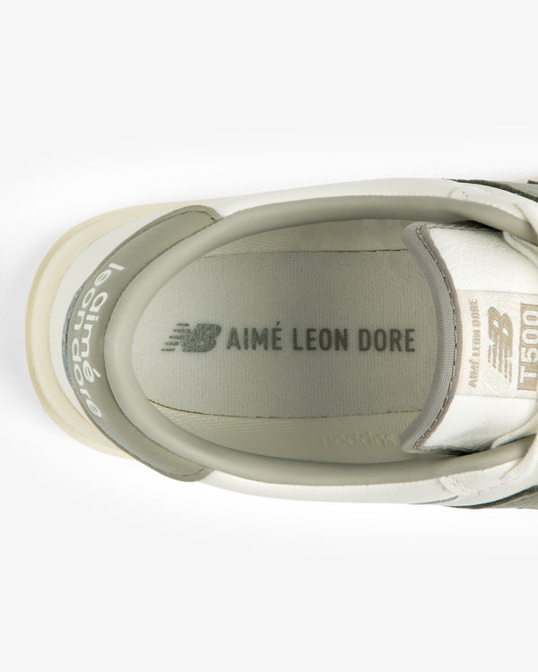 Top-down view of the inside of an ALD / New Balance T500 Tennis Oxford, showing the branded insole and tongue label.