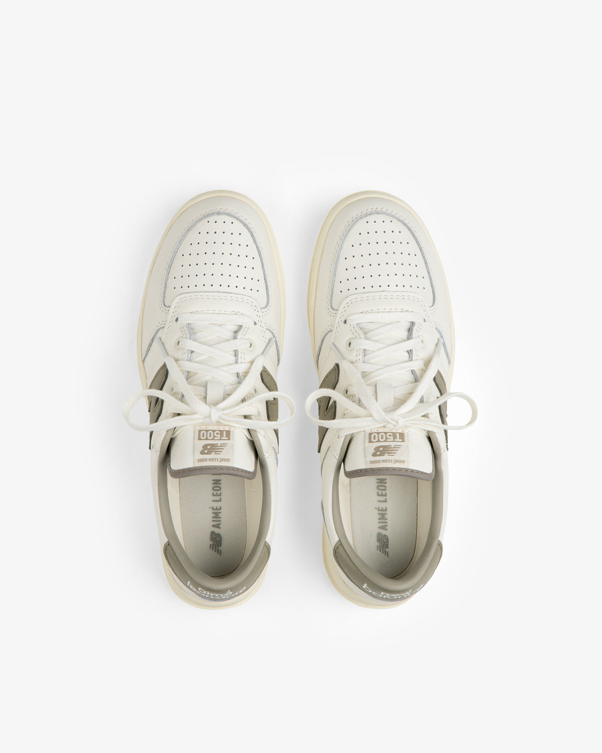 Top-down view of ALD / New Balance T500 Tennis Oxfords in off-white leather with grey accents and perforated toe boxes.