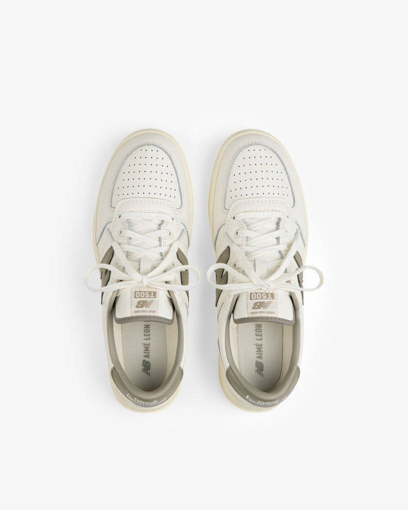 Top-down view of ALD / New Balance T500 Tennis Oxfords in off-white leather with grey accents and perforated toe boxes.