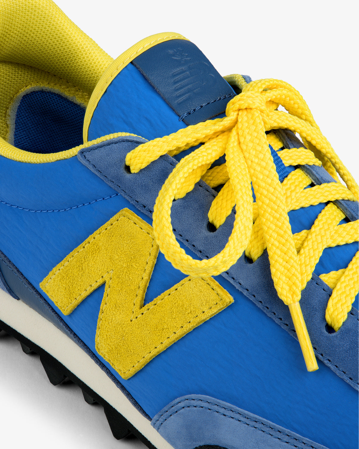 ALD / New Balance Gator athletic shoe in blue and yellow with a yellow N logo and yellow laces.