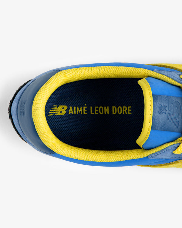 Top-down view of the ALD / New Balance Gator sneaker interior showing a blue and yellow insole with the brand logo.