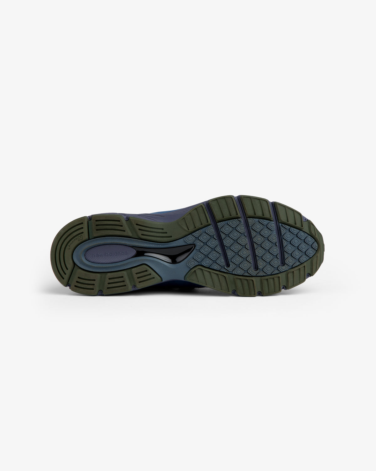New Balance Made in USA 990v4: green and black rubber sole with textured tread, shown bottom-up on white.