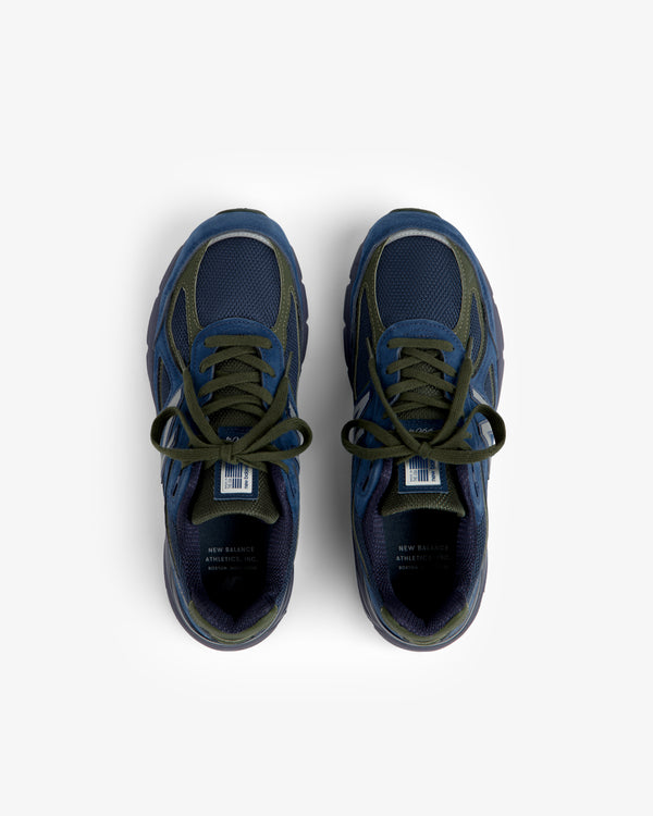Blue and green New Balance Made in USA 990v4 sneakers with laces, top view on a white background.