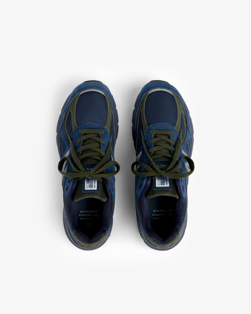 Blue and green New Balance Made in USA 990v4 sneakers with laces, top view on a white background.