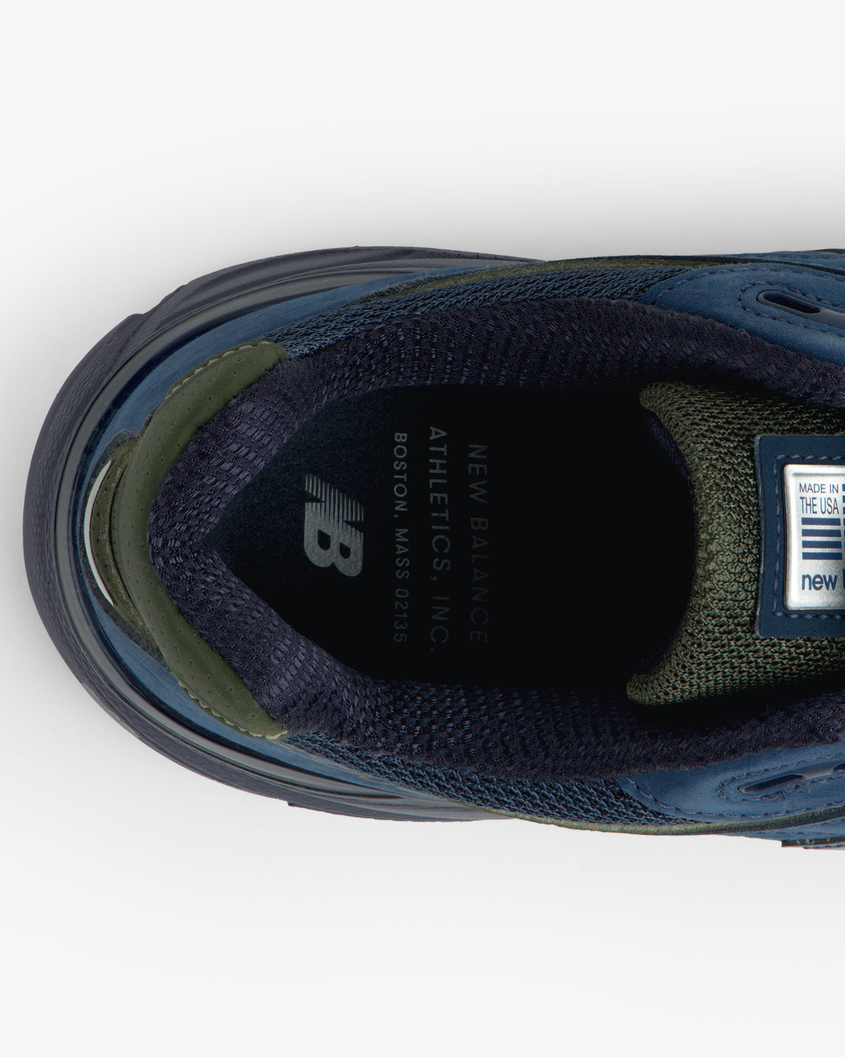 Top view of blue/green New Balance Made in USA 990v4 sneaker showing branded insole.