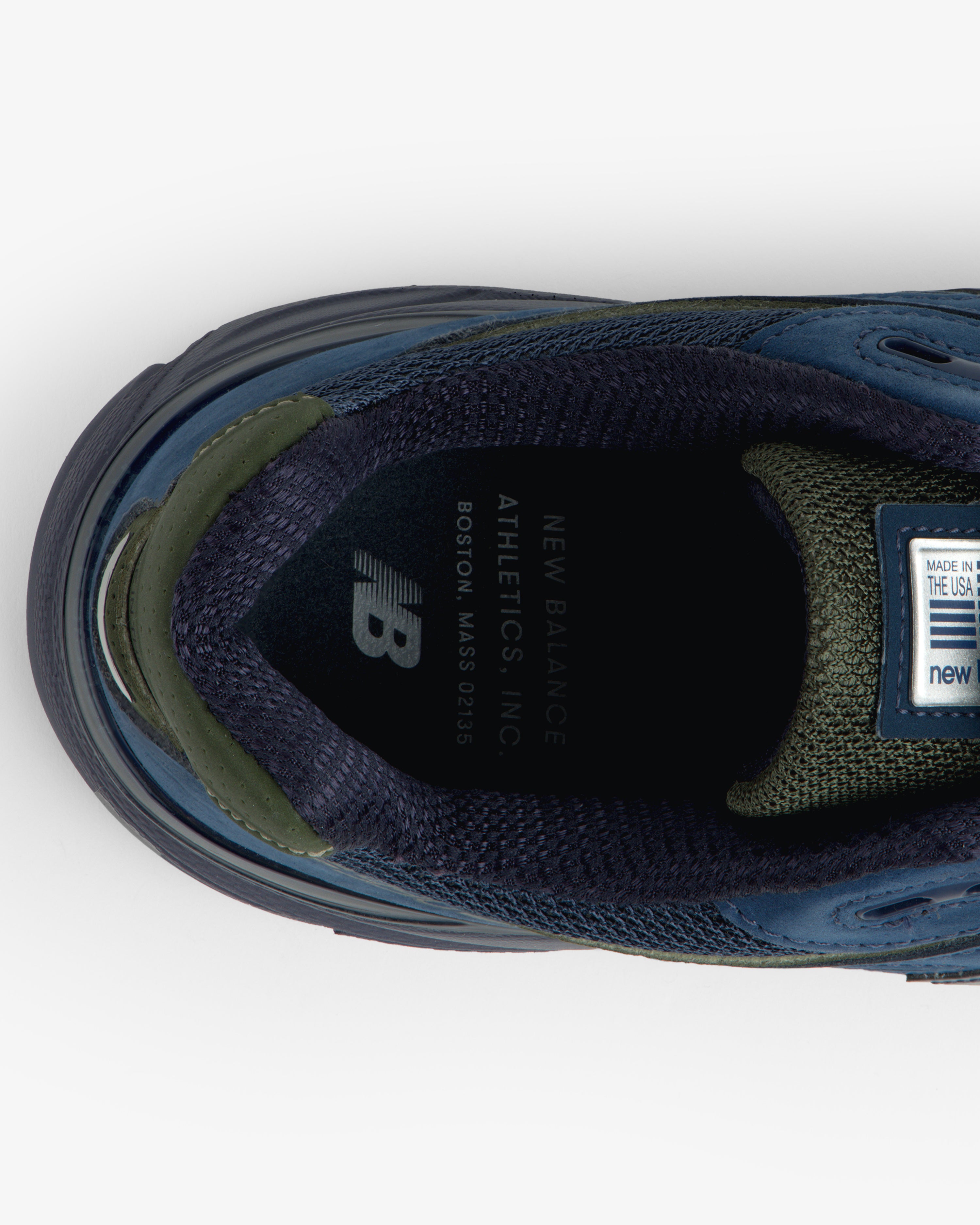 Top view of blue/green New Balance Made in USA 990v4 sneaker showing branded insole.