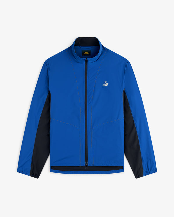 A blue ALD/New Balance Performance Nylon Jacket with black side panels and a white logo on the left chest.