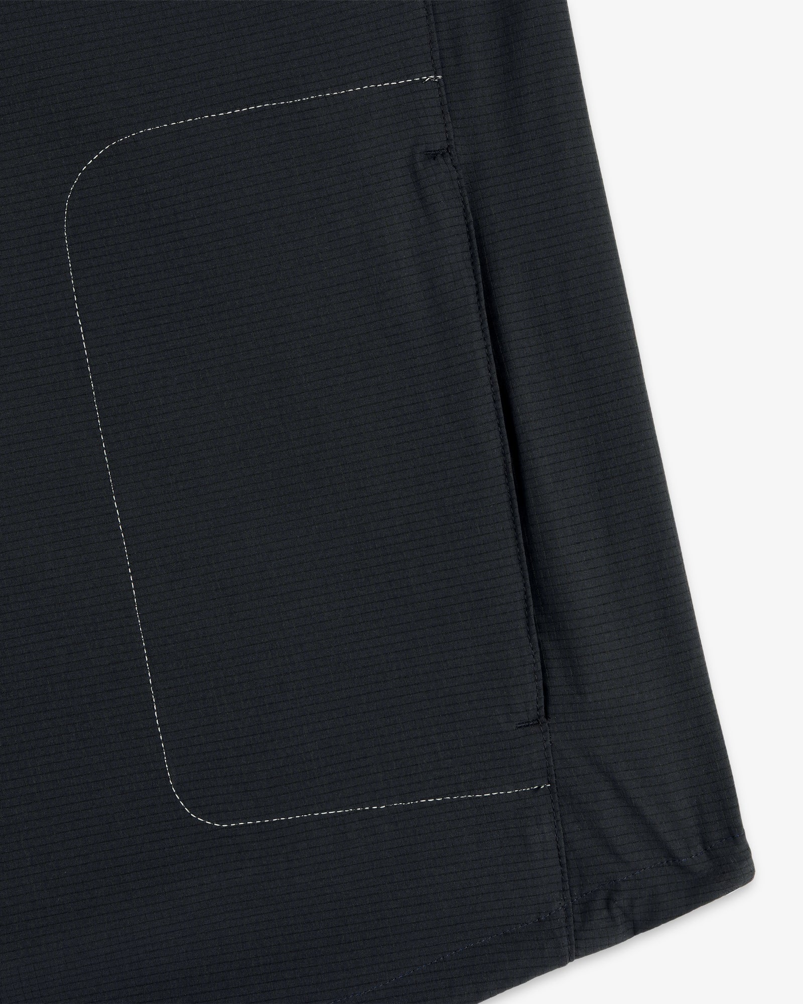 Close-up of the ALD / New Balance Performance Nylon Jacket showing side seam, white stitching, and pocket detail.