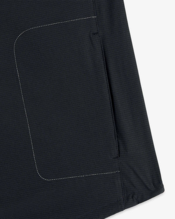 Close-up of the ALD / New Balance Performance Nylon Jacket showing side seam, white stitching, and pocket detail.