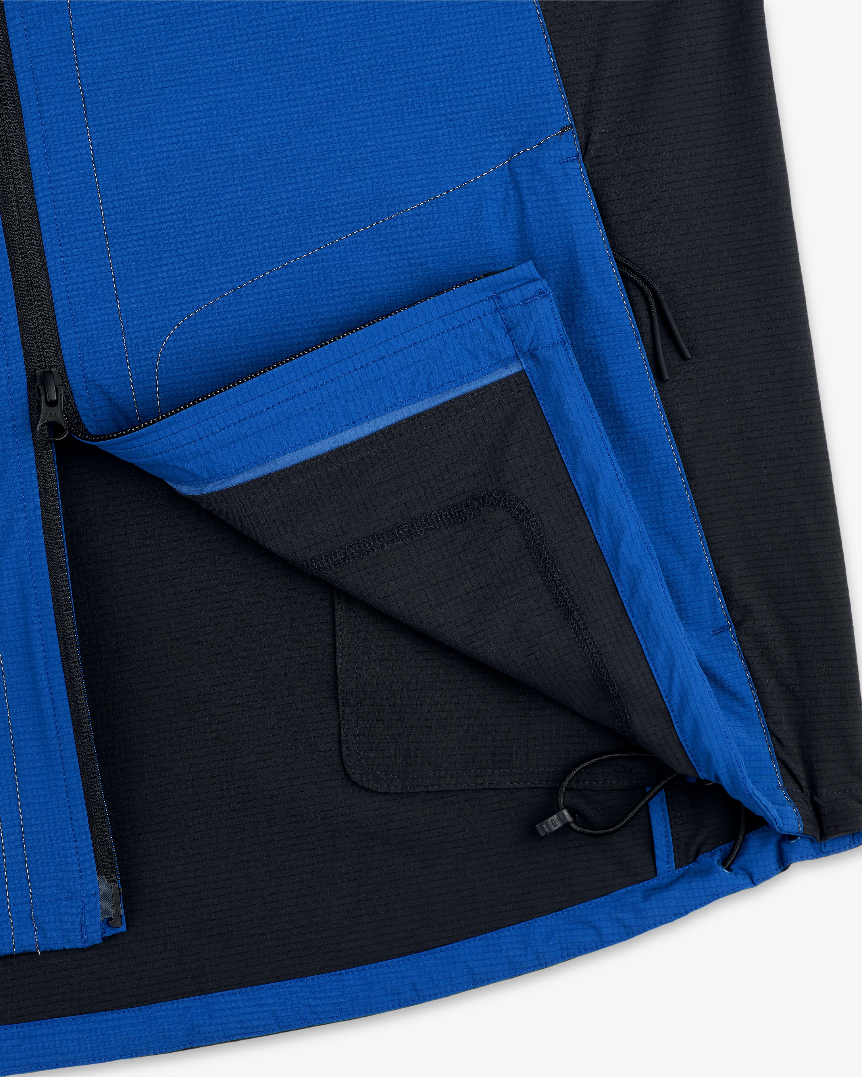 Close-up of the inside pocket and hem drawcord of the ALD / New Balance Performance Nylon Jacket.