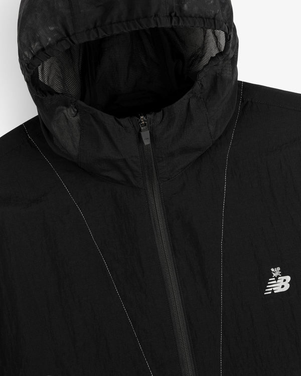 Close-up of a black ALD / New Balance Breathable Half-Zip Pullover with a visible zipper and chest logo.