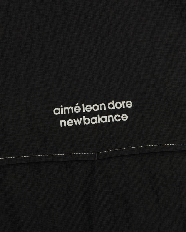 Black ALD / New Balance Breathable Half-Zip Pullover with white logo text and a visible stitched seam below.