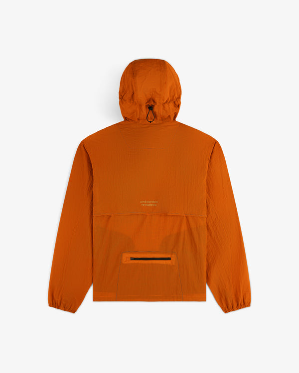 ALD / New Balance Breathable Half-Zip Pullover in bright orange with long sleeves, elastic cuffs, and back zipper pocket.