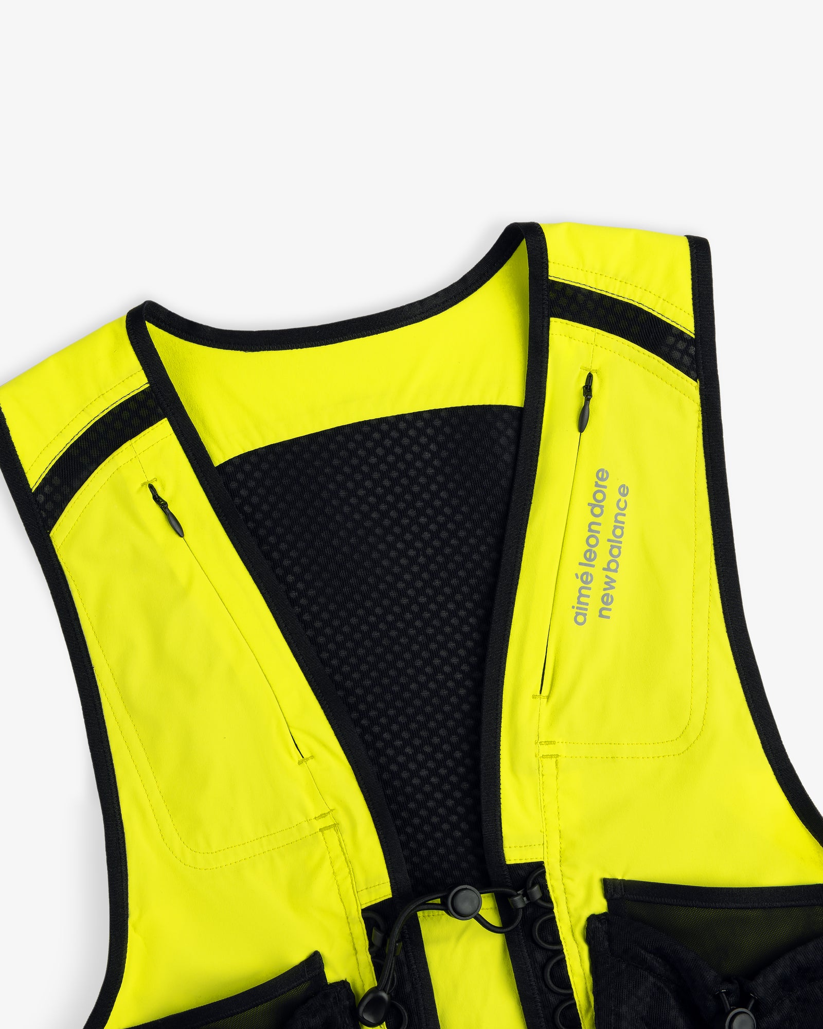 A close-up of the ALD / New Balance Hydrovest in yellow and black with branding on the right side.