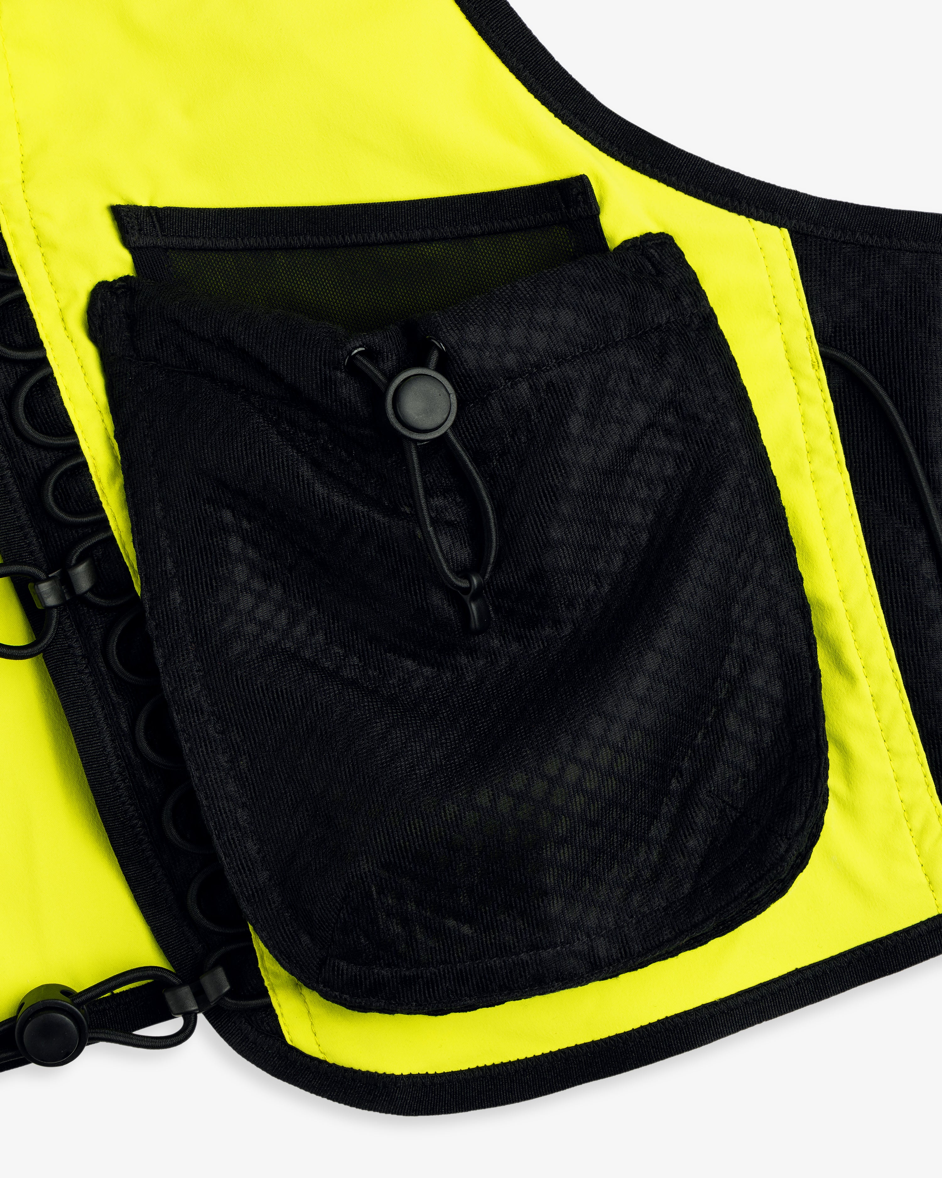 Close-up of a black mesh pocket with drawstring on the yellow and black ALD / New Balance Hydrovest.