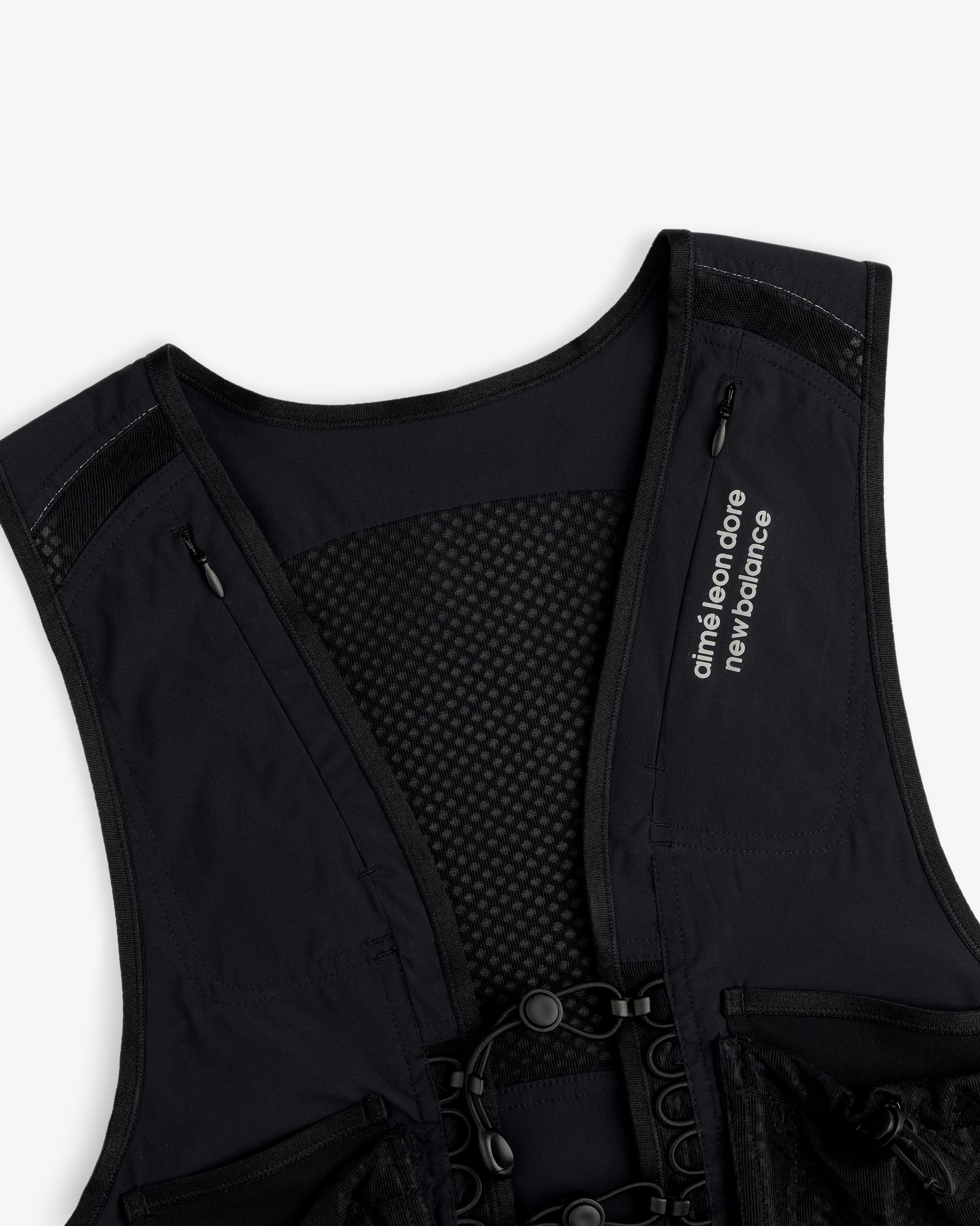 Close-up of a black ALD / New Balance Hydrovest with branding on the left chest.