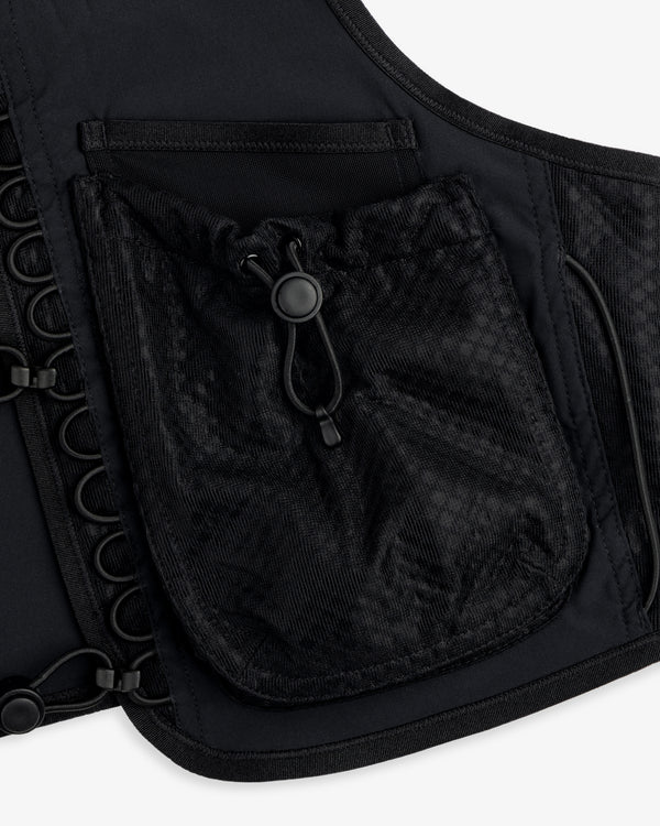 Close-up of the ALD / New Balance Hydrovest, a black vest with mesh drawstring pocket and side grommet details.