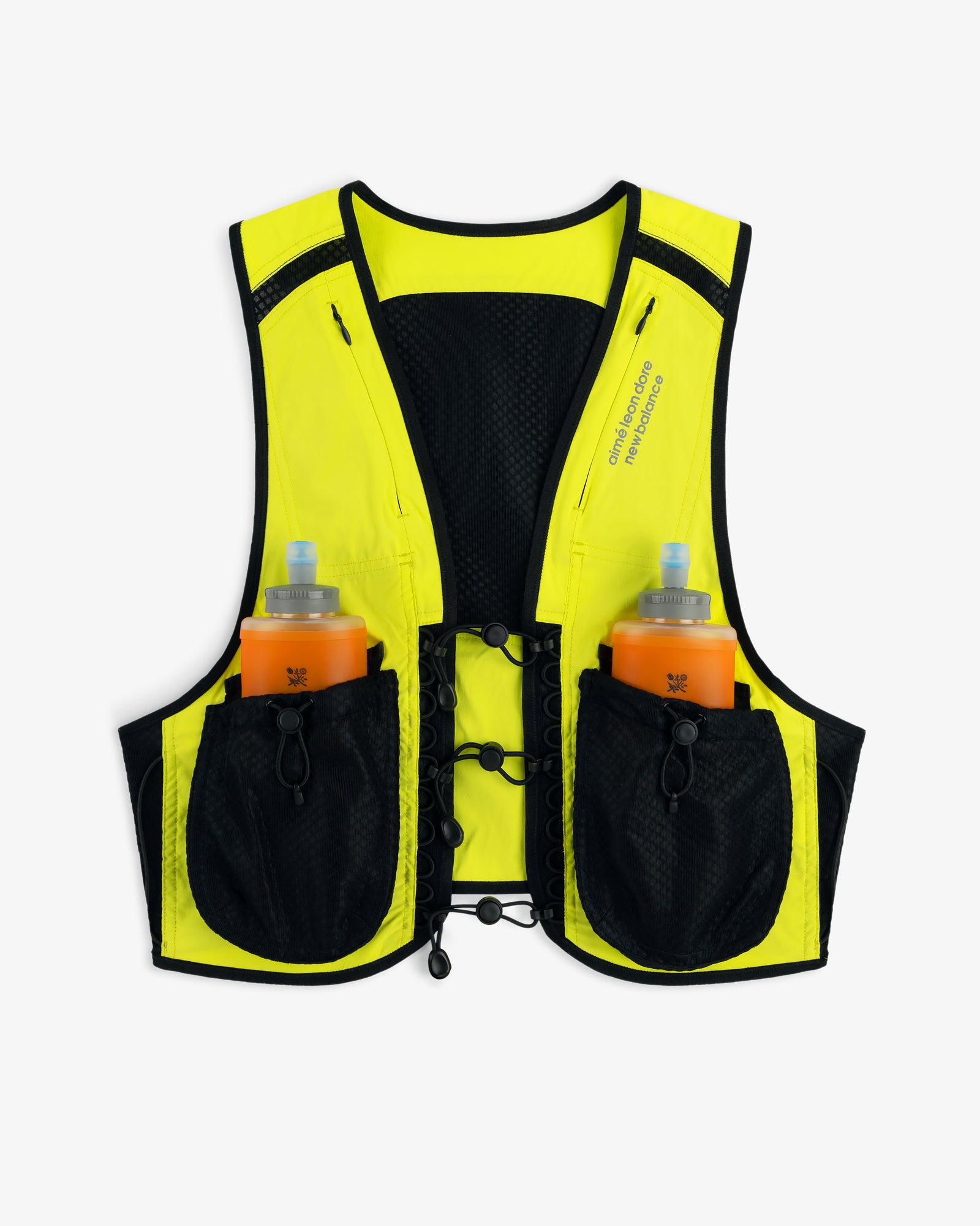 The ALD / New Balance Hydrovest is yellow and black with two orange water bottles in front pockets, shown on white.