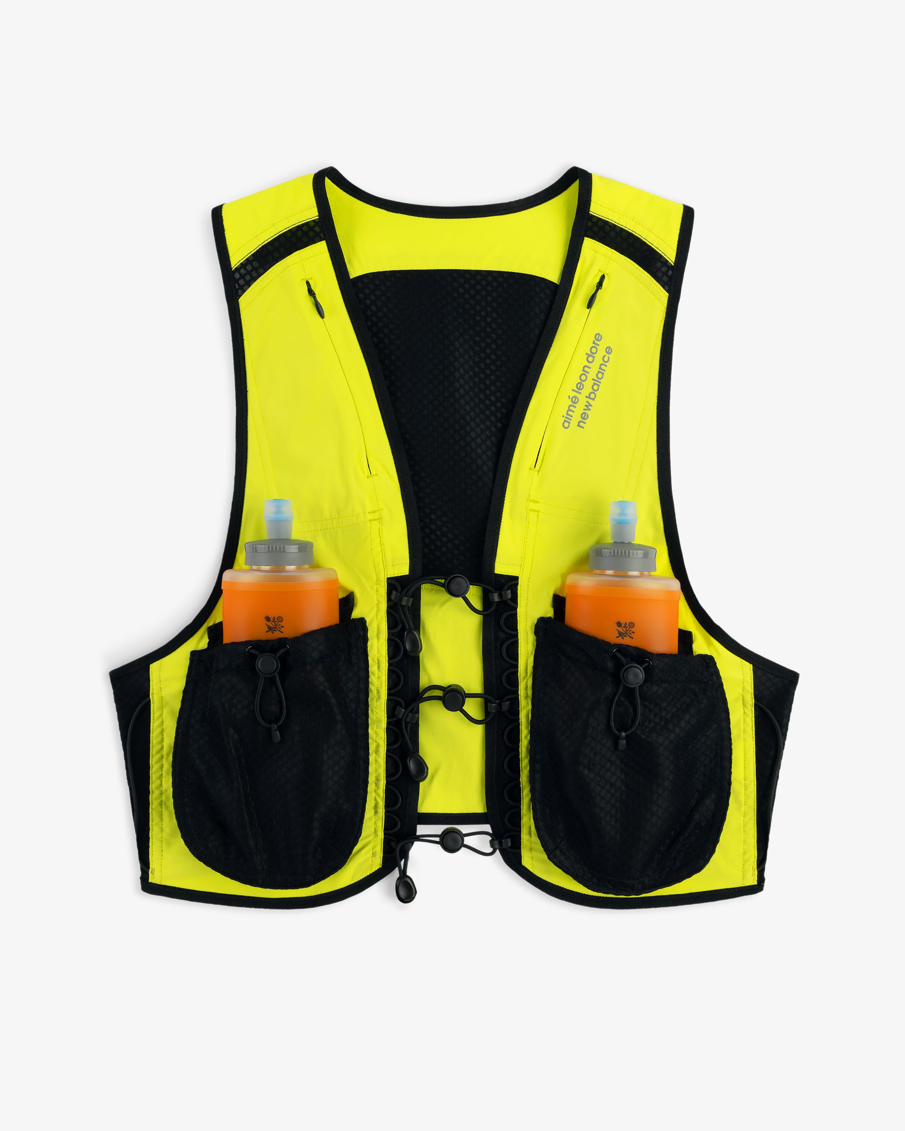 The ALD / New Balance Hydrovest is yellow and black with two orange water bottles in front pockets, shown on white.