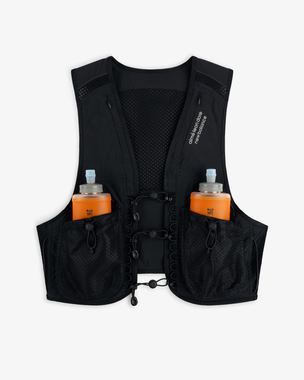 ALD / New Balance Hydrovest in black with two front pockets, each holding an orange water bottle with a blue cap.