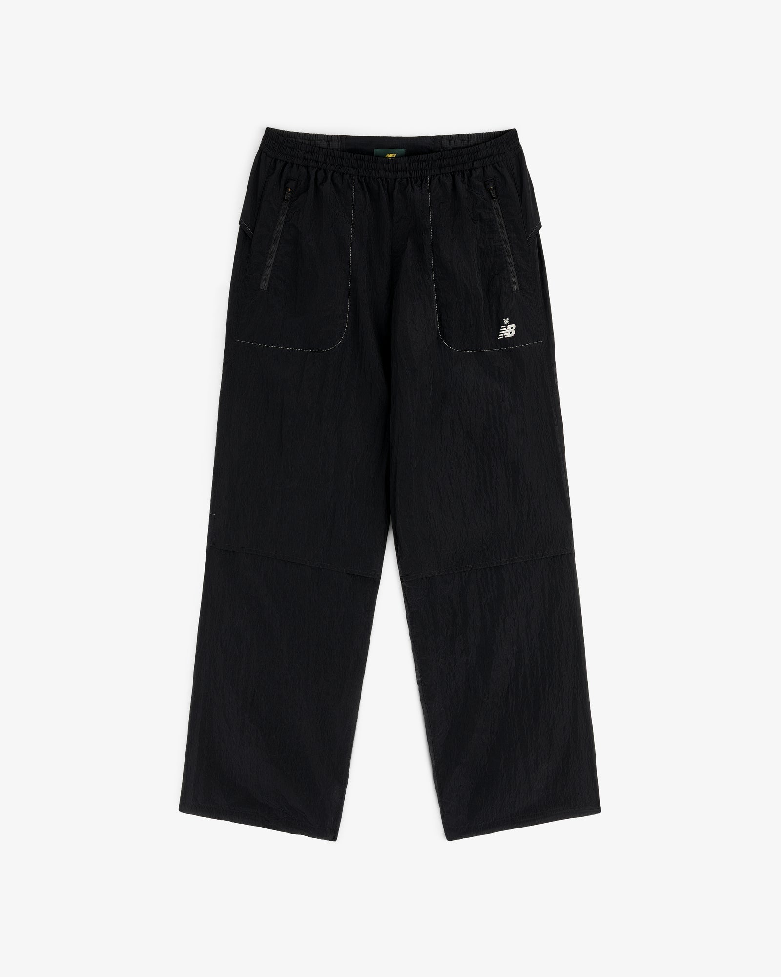 ALD / New Balance Lightweight Nylon Warmup Pant with wide legs, front patch pockets, elastic waist, and white logo.